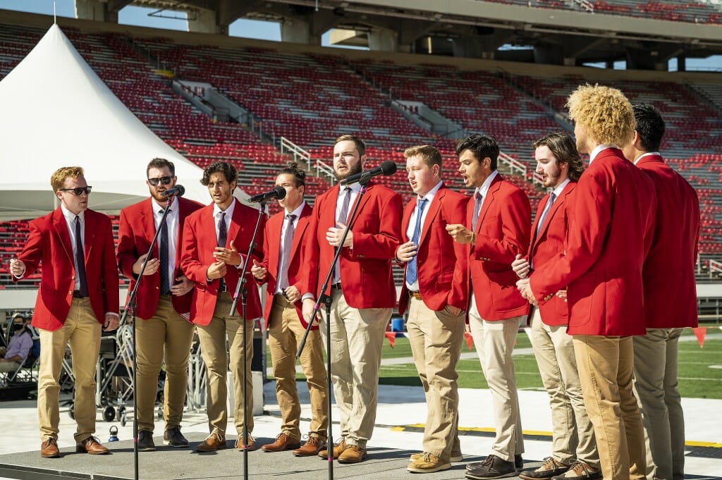 People in red blazers singing