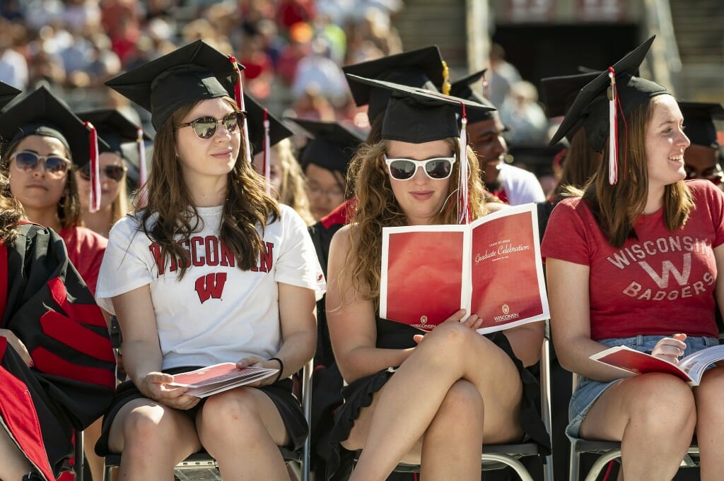 People sitting and looking at booklet