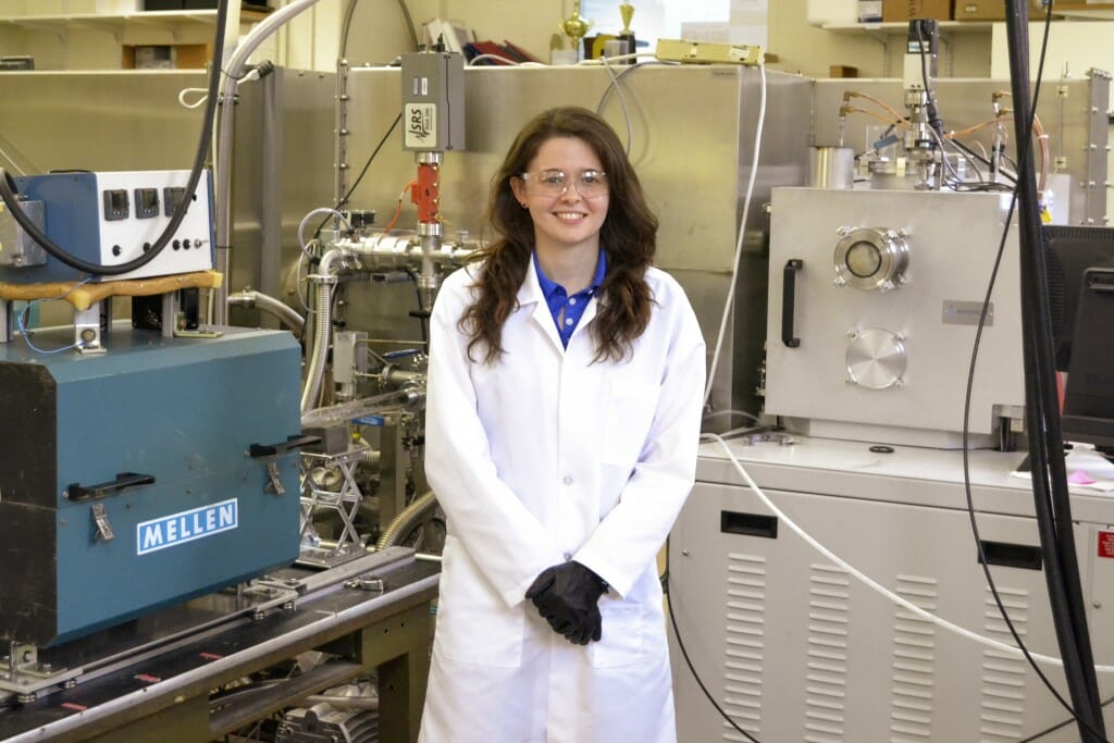 Katherine Jinkins in a lab coat standing in a lab