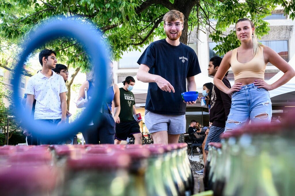 Students Brandt Wall Conklen and Cameron Buzzell play a ring-toss game during a Labor Day Bash event held outside the Middleton Building.