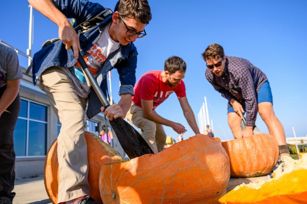 People carving a pumpkin