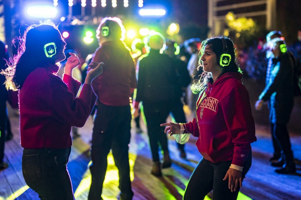 Guests take part in a silent disco during the Homecoming Block Party and Pep Rally at Alumni Park and the Memorial Union Terrace.