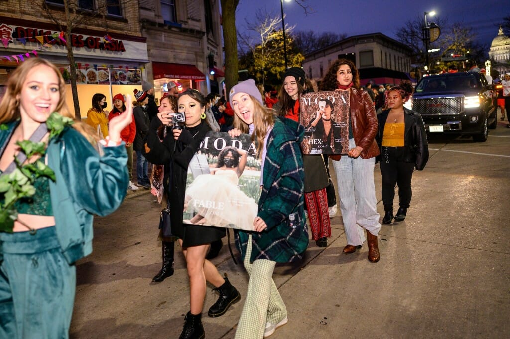Members of Moda Magazine, a UW fashion and style student group, walk in the parade along State Street.
