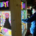 Some kids playing with a light-bright display