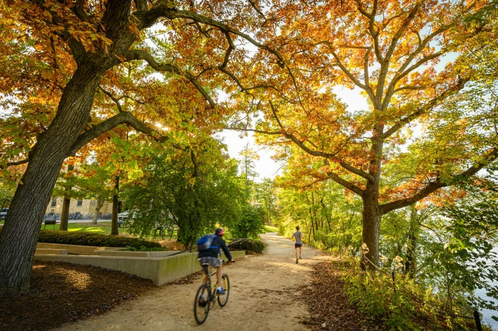 On foot or on wheels, in a hurry or taking your time, exploring the Howard Temin Lakeshore Path (seen here passing Kronshage Residence Hall) will reward you with seasonal scenery around every curve.