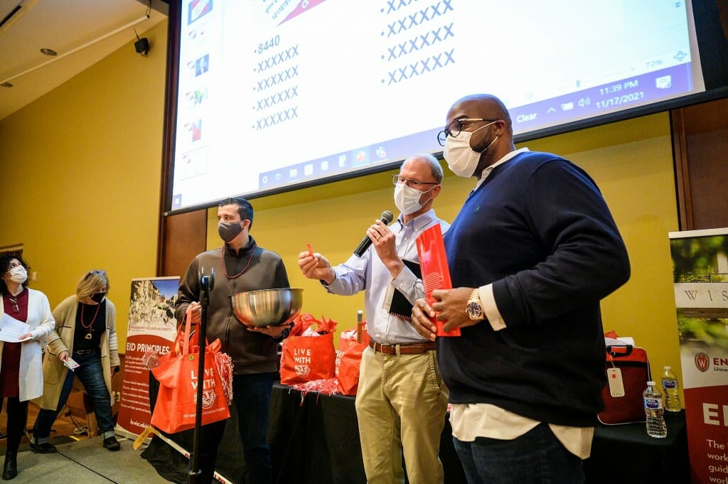 From left and right of center, Rob Cramer, interim vice chancellor for finance and administration, and LaVar Charleston, deputy vice chancellor and chief diversity officer, take turns announcing raffle ticket numbers.