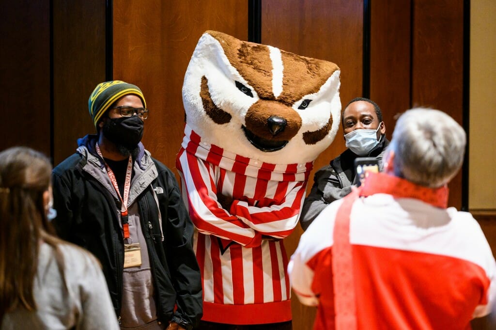 Bucky Badger poses for a photo with attendees.
