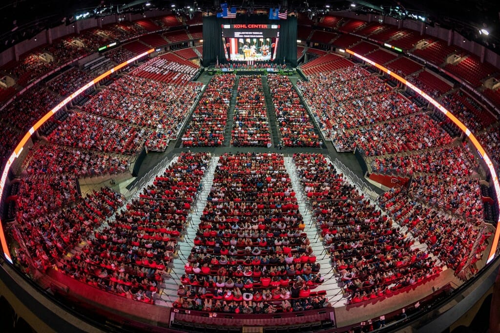 Wide view of interior of Kohl Center filled with students