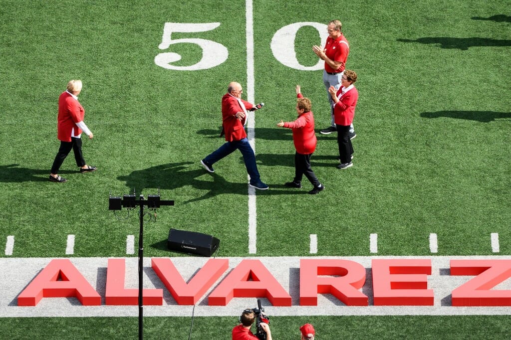 Alvarez and Shalala running toward each other, arms outstretched, while Rebecca Blank and Chris McIntosh watch