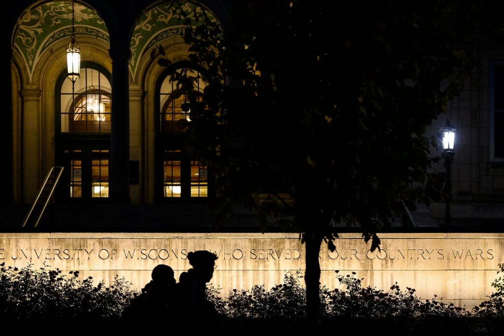 Illuminated sign wall in front of Memorial Union at night