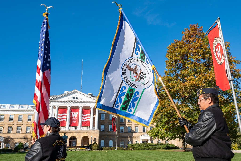 People carrying flags in front of Bascom Hall