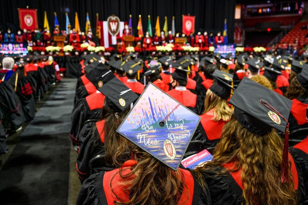 A graduate looks to the future with her mortarboard decorations.