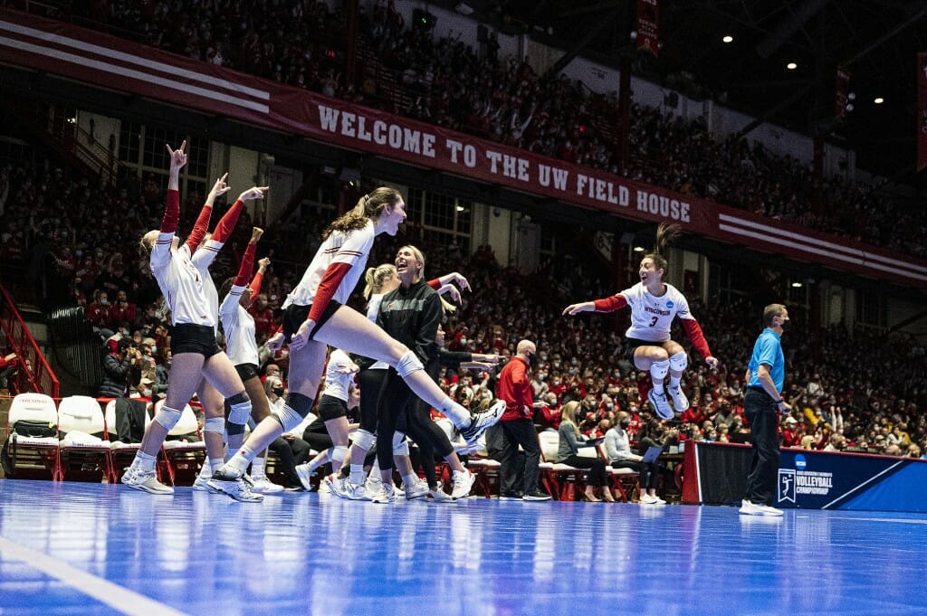 Badgers volleyball players celebrate after winning a set in the NCAA regional final against Minnesota.
