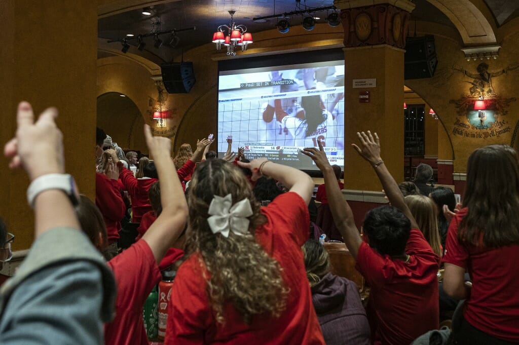 As Dana Rettke trades high fives on the screen, fans trade high fives in Der Rathskeller.