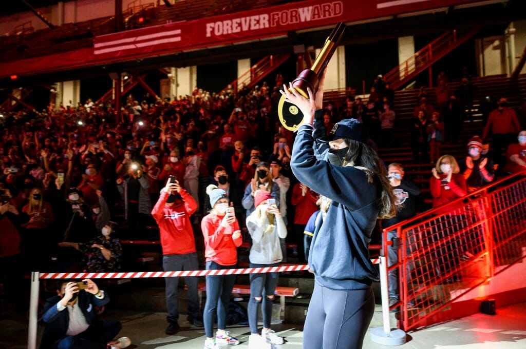 Rettke holding trophy above her head while crowd cheers