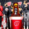 The 2021 NCAA Division I Volleyball Championship trophy is displayed front and center as hundreds of Badger fans welcome the Wisconsin volleyball team – now the 2021 NCAA Volleyball Champions – back to the Field House at the University of Wisconsin–Madison on Dec. 19, 2019. The Wisconsin Badgers won the national volleyball title – the team’s first ever – the night before after defeating Nebraska Cornhusker 3-2 in a championship game played in Columbus, Ohio. A campus and county health mandate requires people to wear face mask indoors – except while eating or drinking – as the coronavirus (COVID-19) pandemic continues. (Photo by Jeff Miller / UW–Madison)