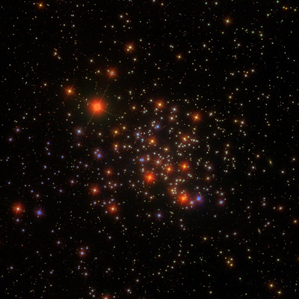 View of many stars in space, some reddish, some white or yellow, some blueish