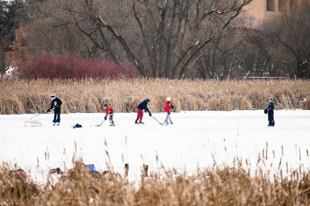 Photo: Boys play on an ice-covered bay.
