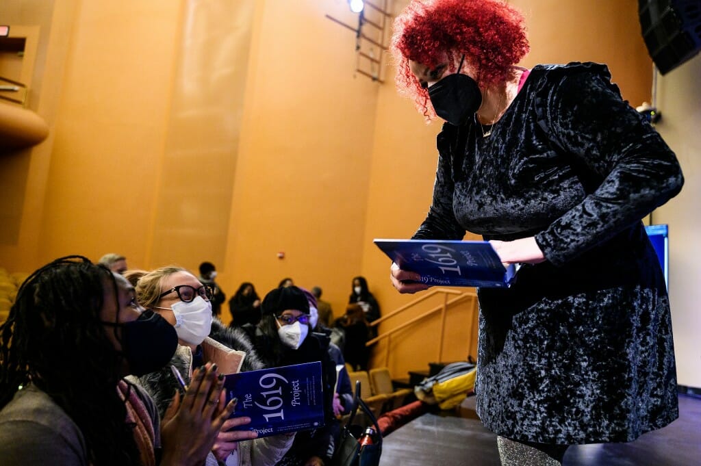 Jones signing a book for an audience member in the auditorium