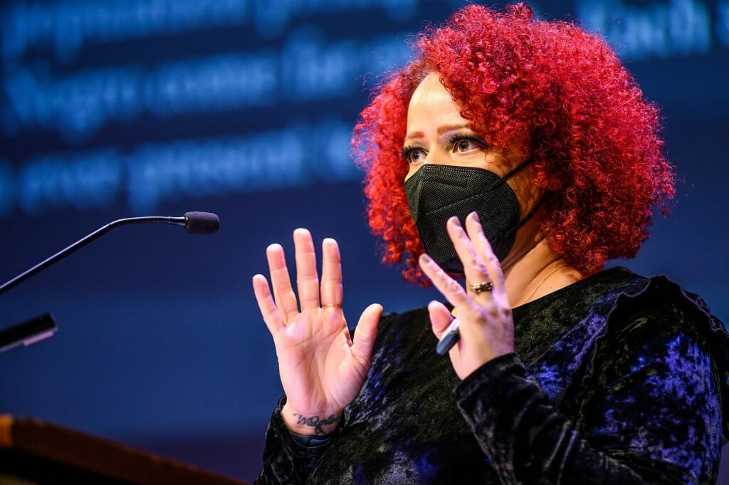 Closeup of Hannah-Jones at podium gesturing with both hands