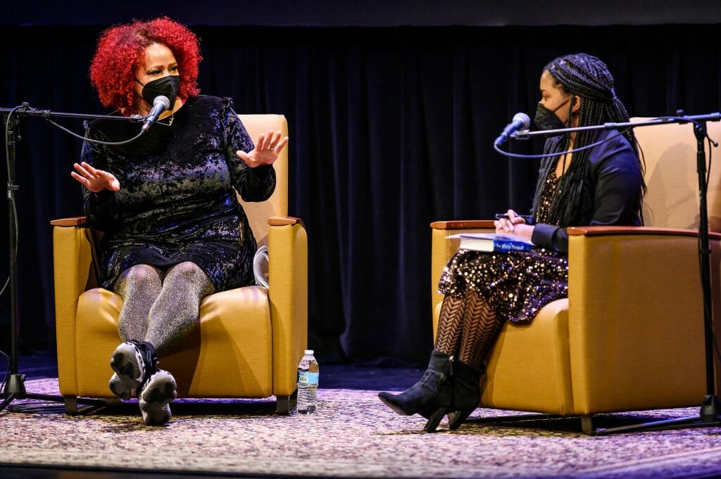 Hannah-Jones and Fowlkes seated on stage, conversing