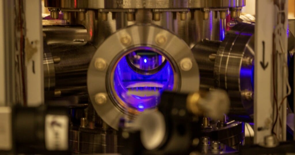 Photo: A mechanical chamber glows blue inside.