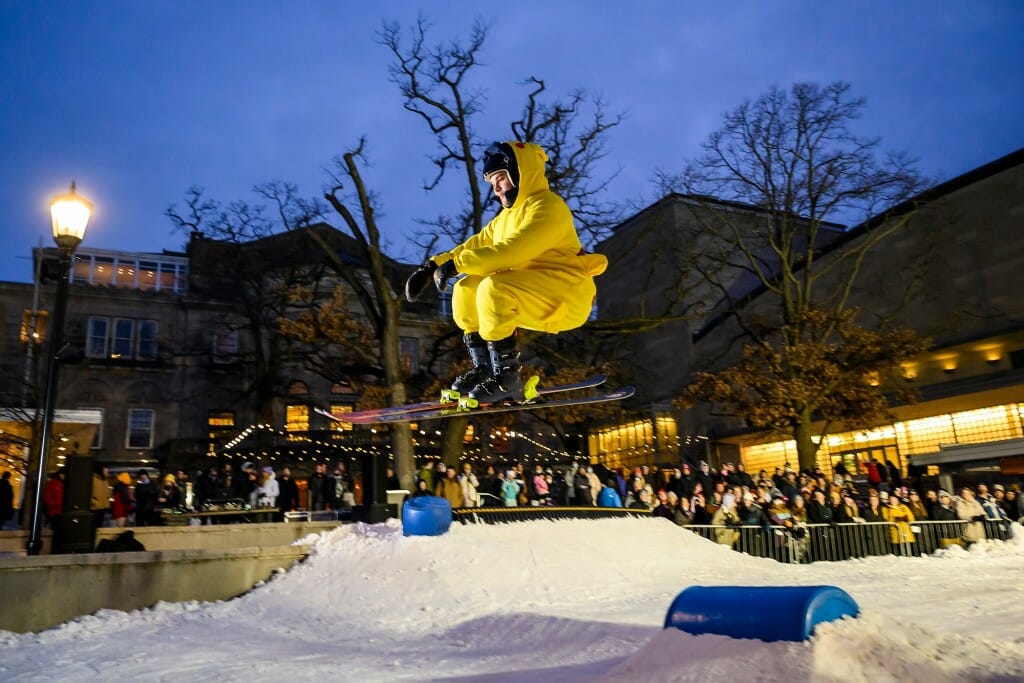 Spectators watch a skier dressed as Pikachu compete during the annual Rail Jam event at the Memorial Union Terrace.