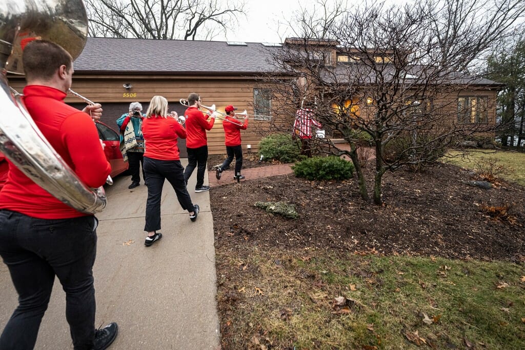 Band members walking up to house