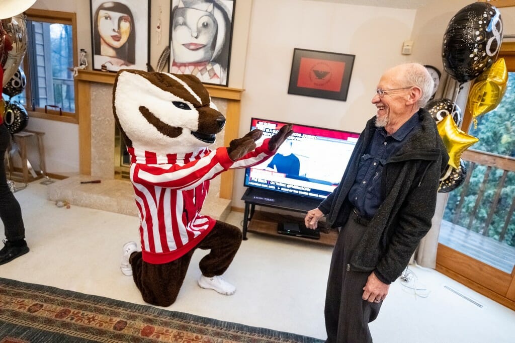 Bucky on his knees bowing to a laughing John Wiley