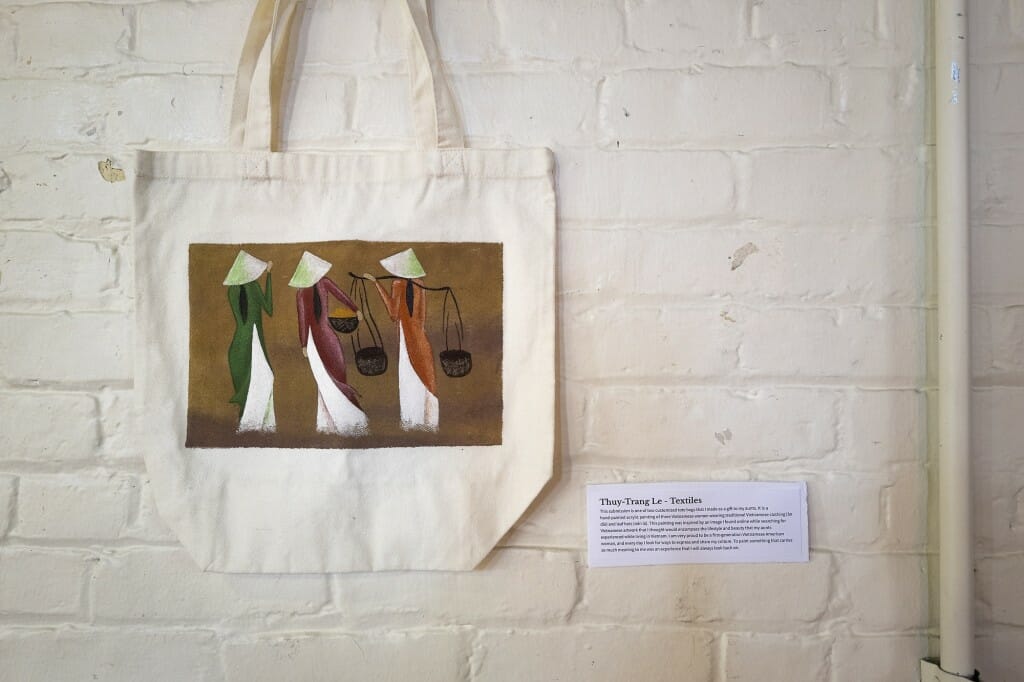 A hand-painted tote bag by Thuy-Trang Le is among student-created artwork on display during  the show.
