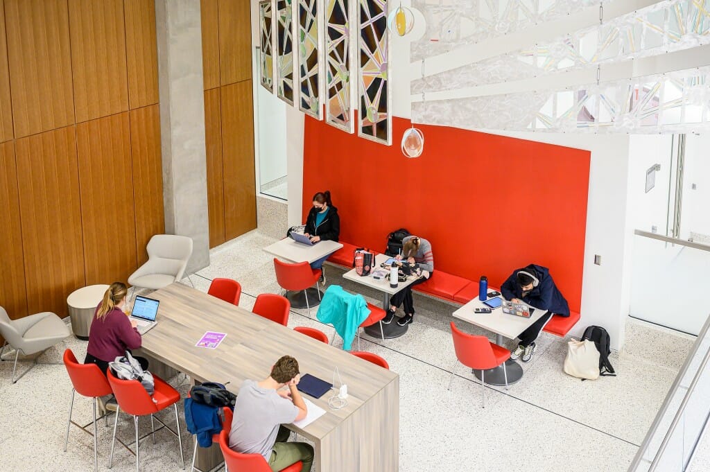 Overhead view of students working at tables in a high-ceilinged room