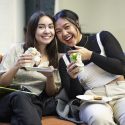Samantha Greco (left) and Allie Ho enjoy spring rolls.