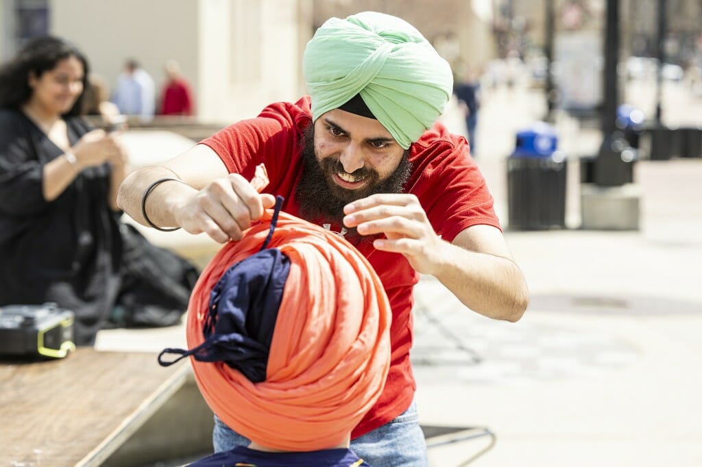 UW student Manmeet Singh Dang puts the finishing touches on this turban tie.