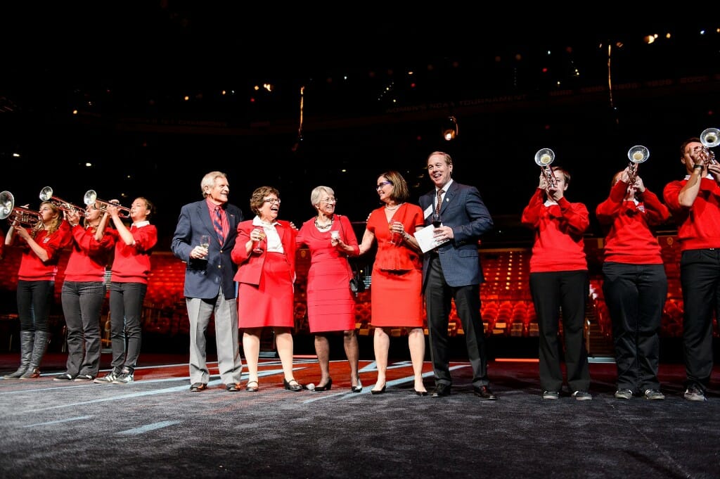 A group of people wearing red lined up on a stage