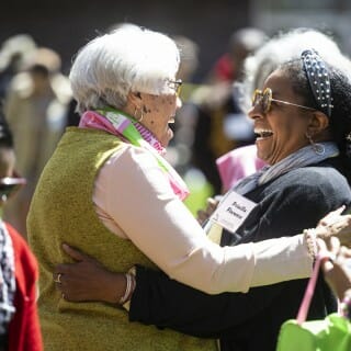Founding members of the UW chapter of the Alpha Kappa Alpha Sorority, Inc., Sara Jackson (left) and Priscilla Florence (right) embrace in a moment of joy during the Divine Nine Garden Plaza grand opening ceremony.