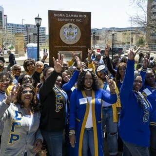 Members of the Sigma Gamma Rho Sorority, Inc., celebrate and take photos as their plaque makes its debut.