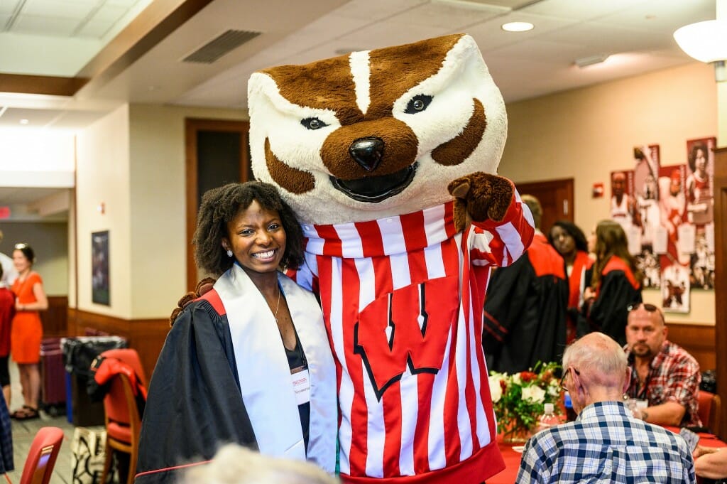 Bucky poses with recent UW graduate Furaha Niyomurinzi at the Commencement Luncheon.