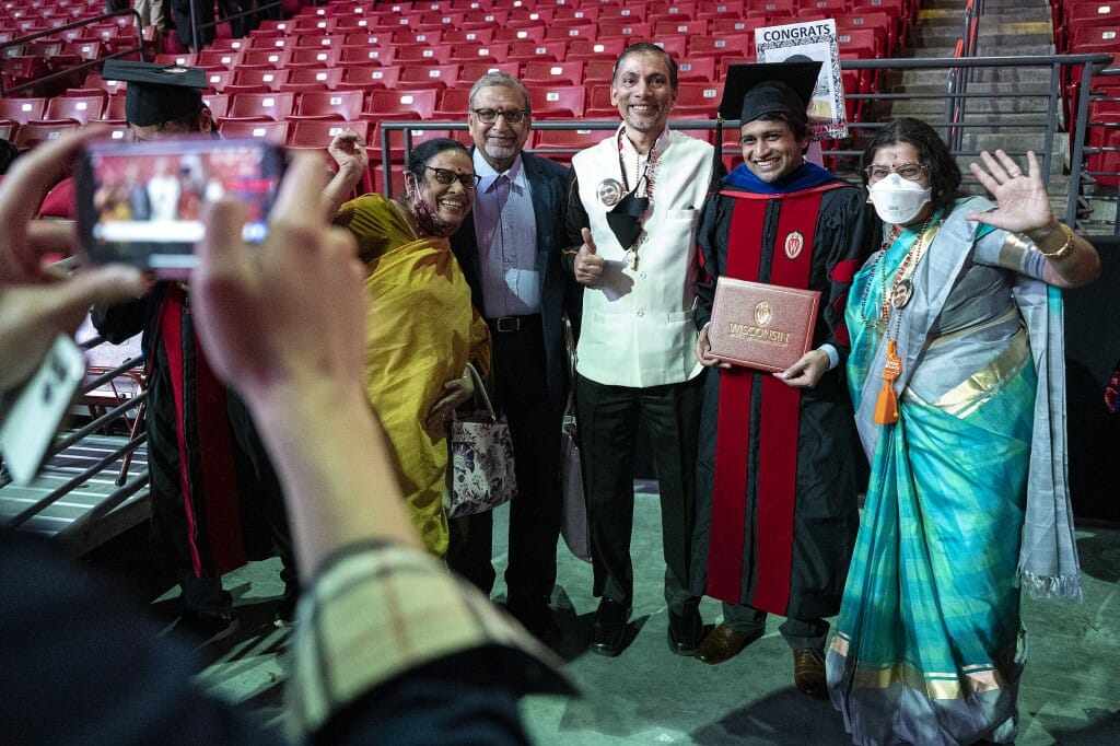 Ravi Raju, graduating with a PhD in electrical engineering, poses for a photo with family members.
