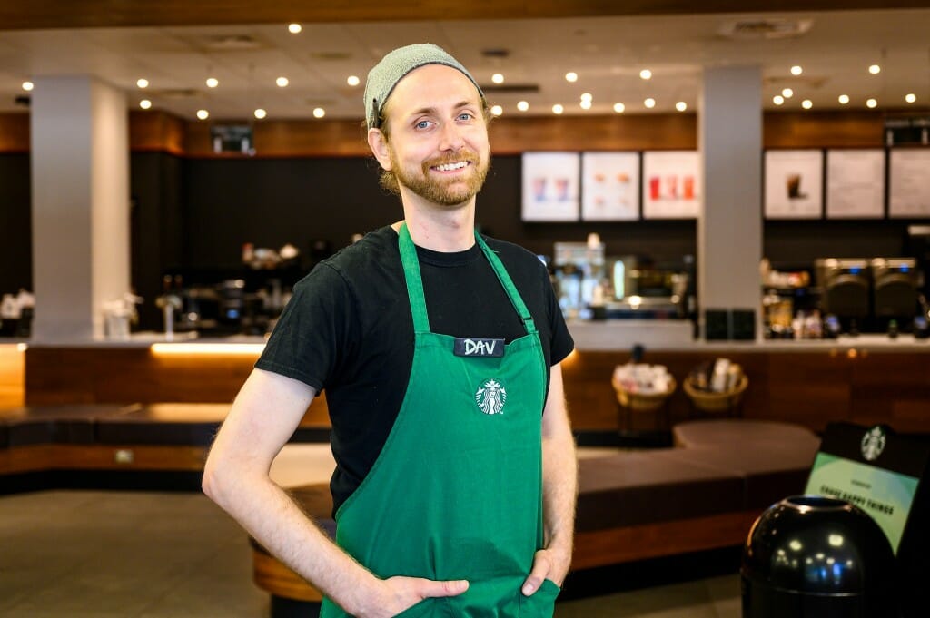 Marburger standing in a green apron