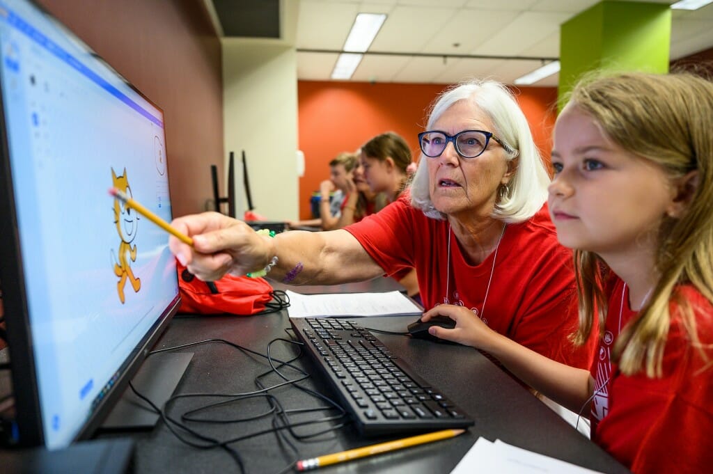 At left, Nancy Gardner and Weezy Eckstrom work together to code a racecourse using the programming language Scratch during a Grandparents University Computer Science class in the Computer Sciences building.