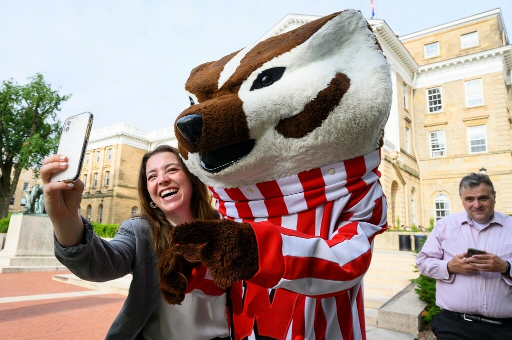 Hannah Chauvin, USDA senate staffer, takes a selfie with UW mascot Bucky Badger in front of Bascom Hall during the tour.