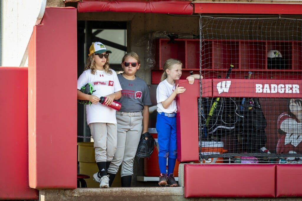 Part of the fun of softball is watching from the dugout, these girls learned at softball camp.