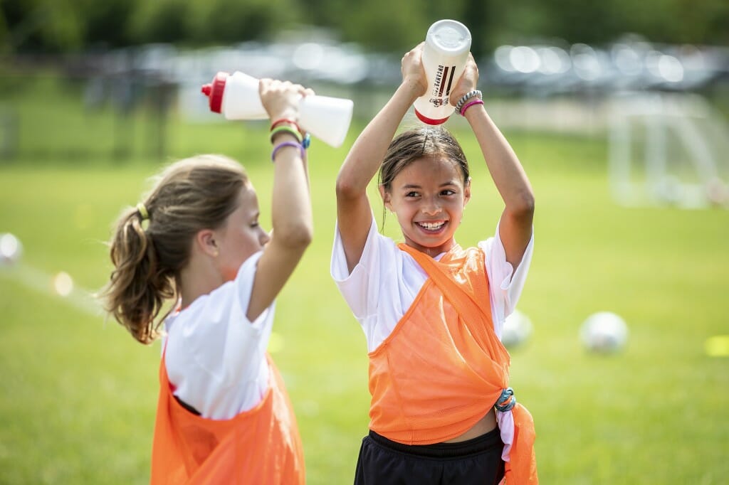 These girls learned a soccer camp lesson: On a hot day, water is a good way to cool off.
