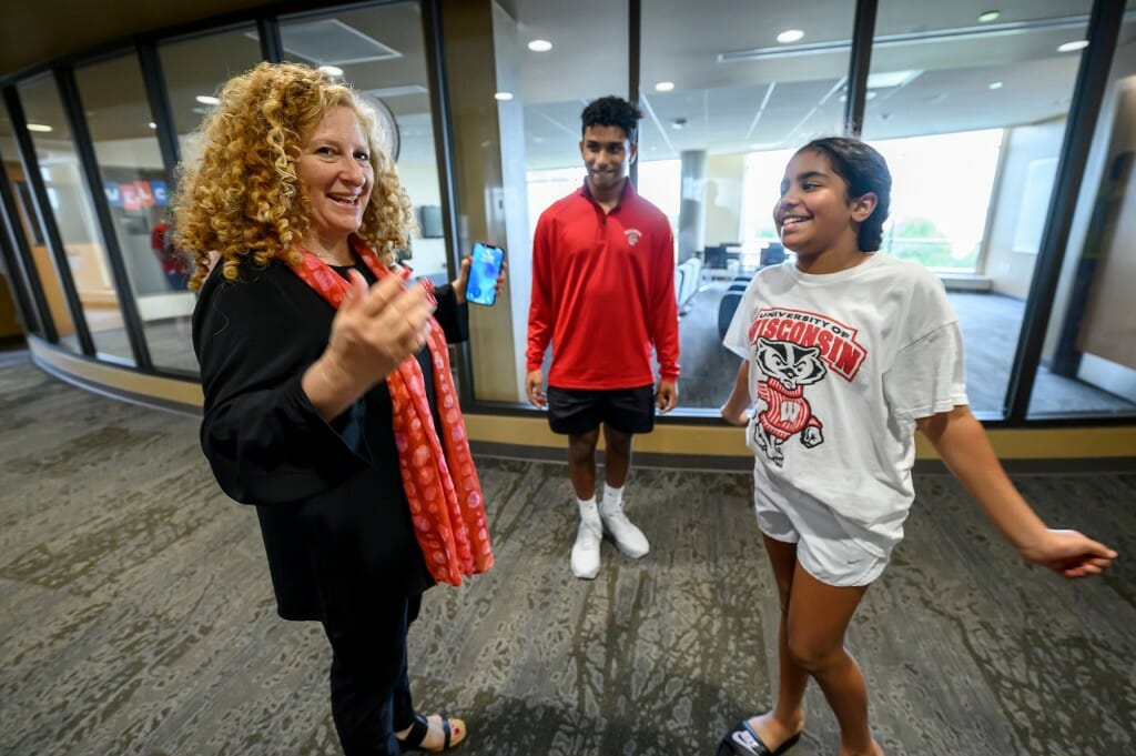 At left, Chancellor Mnookin invites 11-year-old Sophia to consider a future as a Badger like her brother, first-year student Aaron Mathew from Allentown, NJ.  Mathew’s family was helping him move into the Dejope Residence Hall.