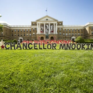 A sign on the Bascom Hill lawn reads: "On Wisconsin! Chancellor Mnookin"