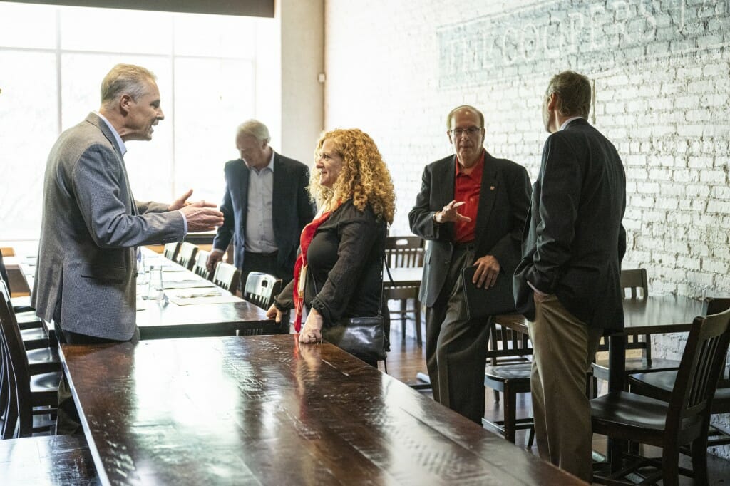 Chancellor Mnookin stands as she meets with the CEO of Alliant Energy