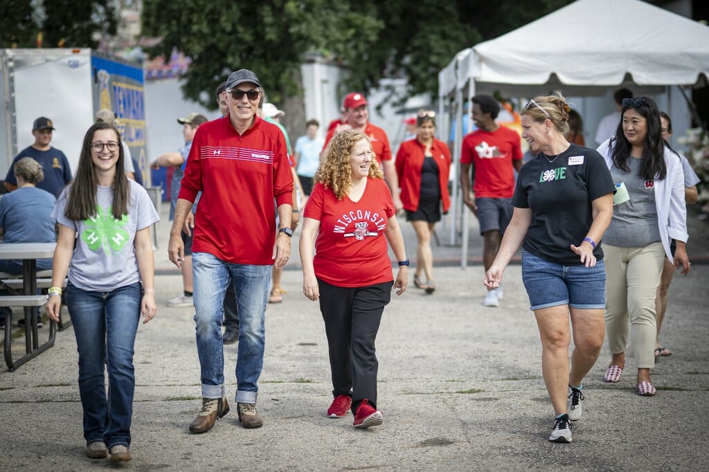 Chancellor Mnookin walks the grounds with her husband Joshua Foa Dienstag and UW Extension Educator Melinda Pollen.