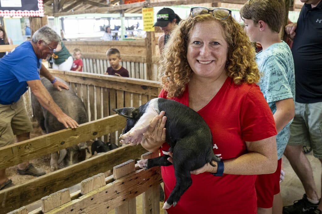 Chancellor Mnookin holds a piglet at the Brown County Fair.
