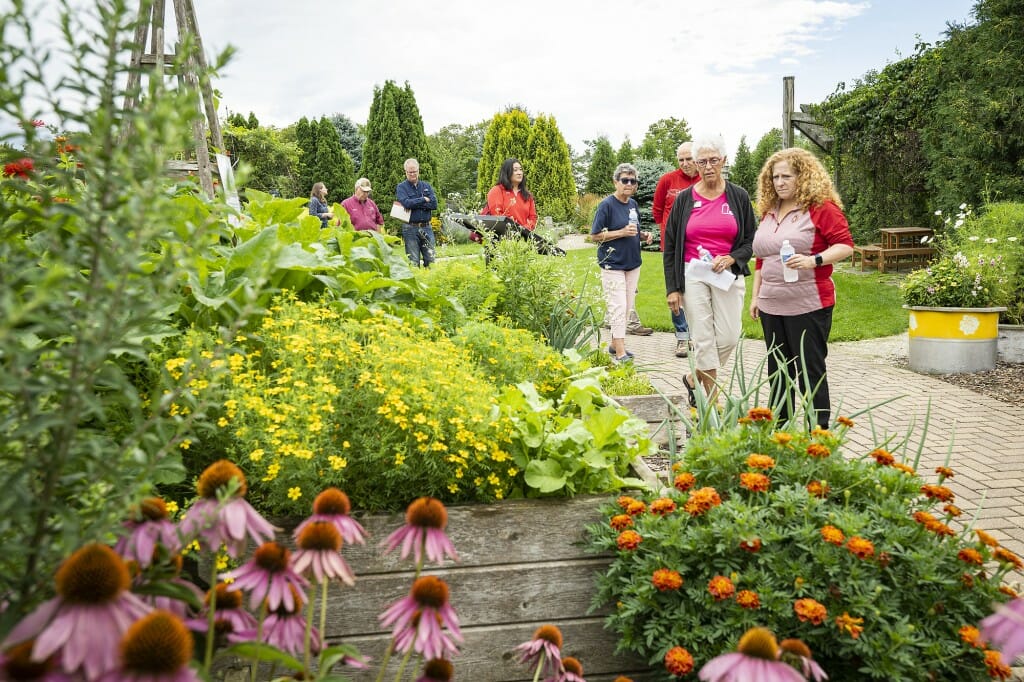 Chancellor Mnookin listens to Door County master gardener Sue Kunz as she tours the Garden Door public gardens.