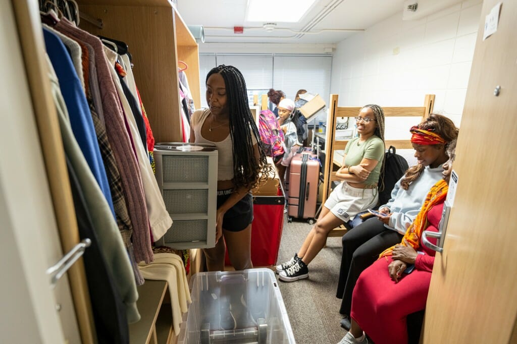 Space is at a premium, so unpack strategically. Msuya from Minneapolis squeezes what she can in her closet at Witte with the help of family members.